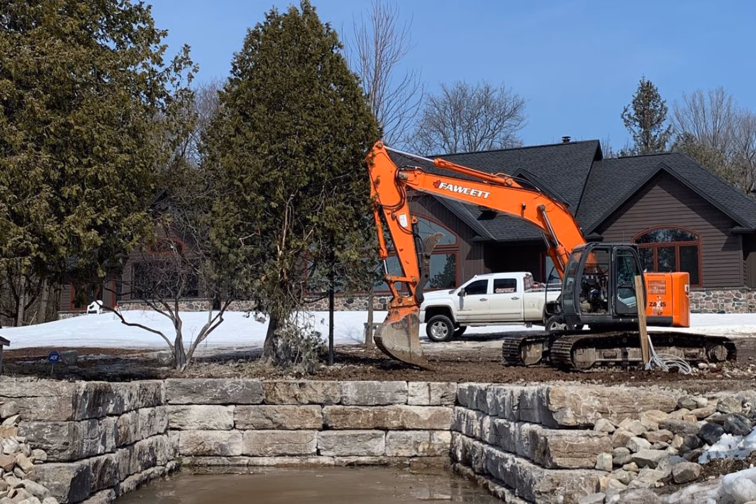 Excavator digging a utility trench in Bobcaygeon