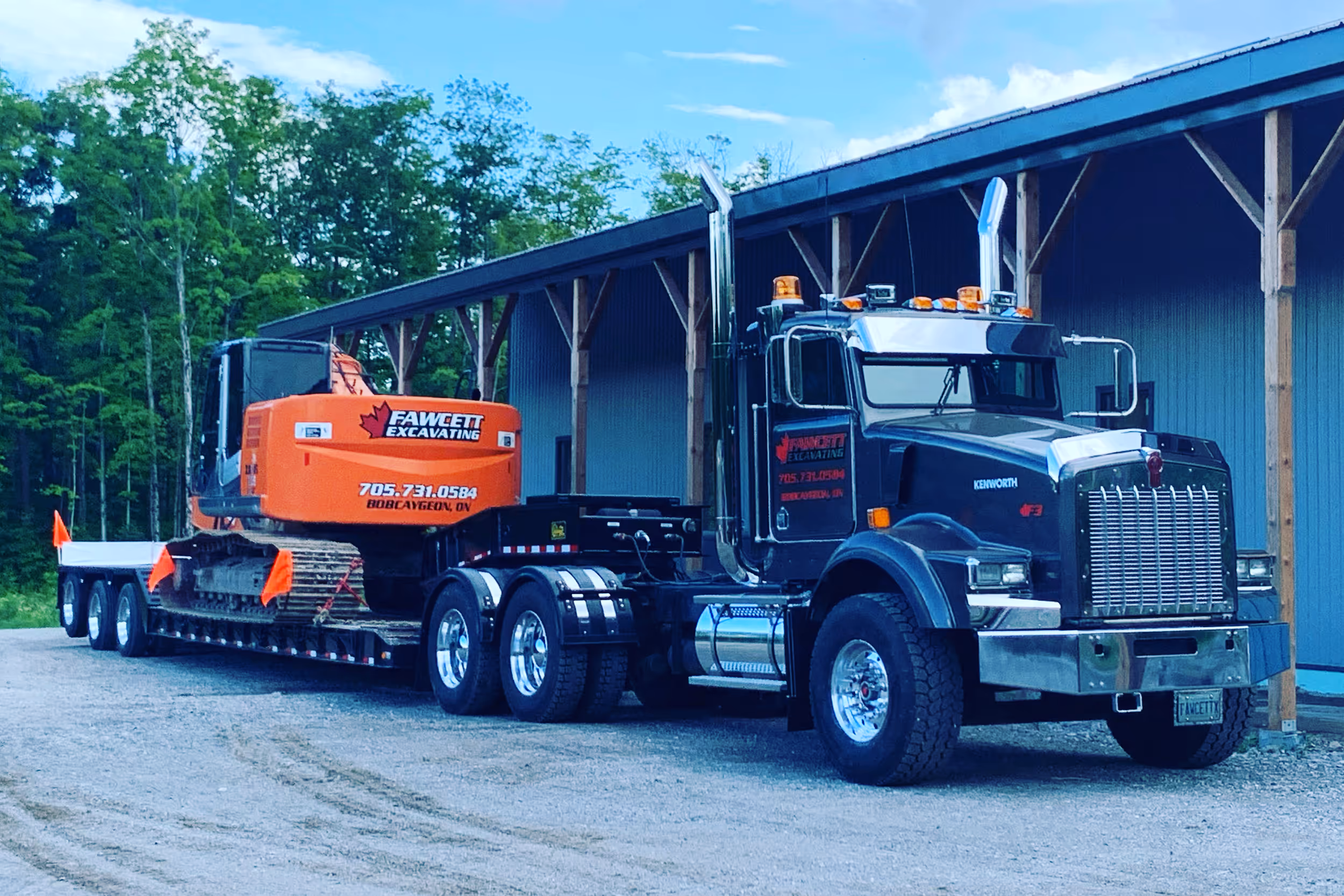 Large transport truck used for hauling equipment or materials by Fawcett Excavating